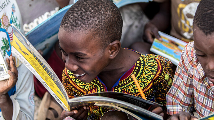 Happy learners are guided to better literacy by local mentors and trained staff.